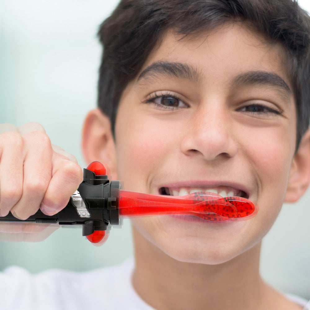Child brushing teeth with Firefly Star Wars Red Lightsaber toothbrush