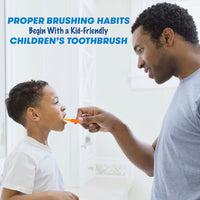 Father brushing child's teeth with orange Firefly light up toothbrush, Proper brushing habits begin with kid-friendly children's toothbrush