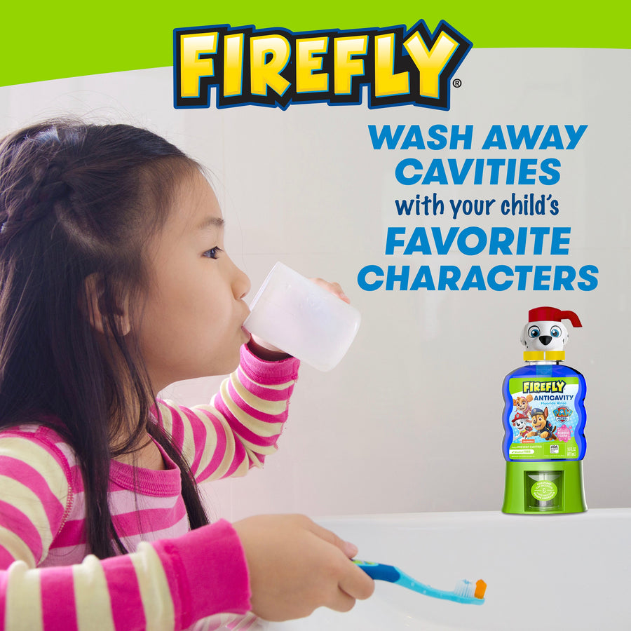 Child sipping a cup at the sink holding Firefly Toothbrush, Wash away cavities with your child's favorite characters