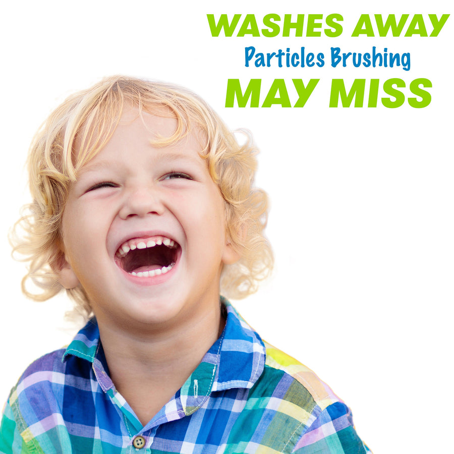 Child smiling. Washes away particles brushing may miss
