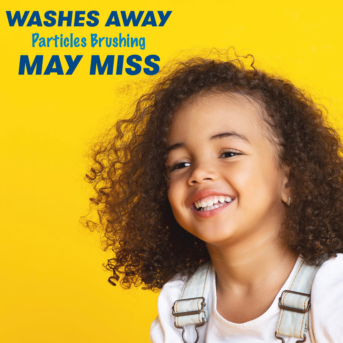 Child smiling. Washes away particles brushing may miss